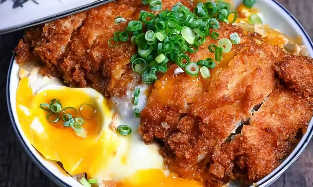 Crispy pork cutlet over rice with a runny egg at Fuji Ramen Japanese Cuisine, a Japanese Restaurant in New Philadelphia